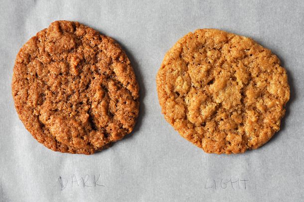 A cookie made with dark brown sugar on the left side, and a cookie made with light brown sugar on the right side.