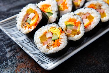 Rows of sliced Korean kimbap, which look similar to sushi and are filled with colorful sliced vegetables 