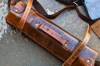 A Rustic Town Genuine Leather Chef Knife Roll with water droplets lying on a surface