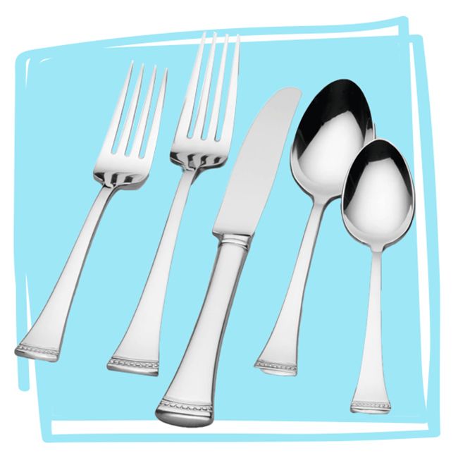A 65piece flatware set including forks knives and spoons arranged on a blue background