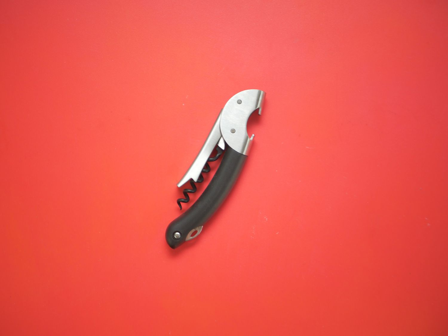 OXO waiter's style wine opener on red surface