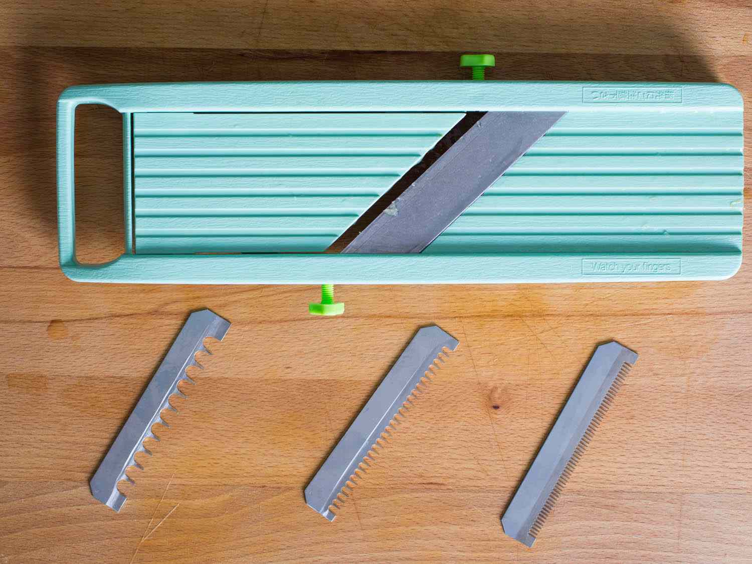 Benriner Mandoline with its blades beside it 