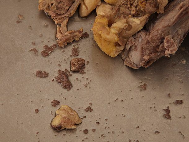 Discarded scum after scrubbing bones used in the chicken/pork broth.