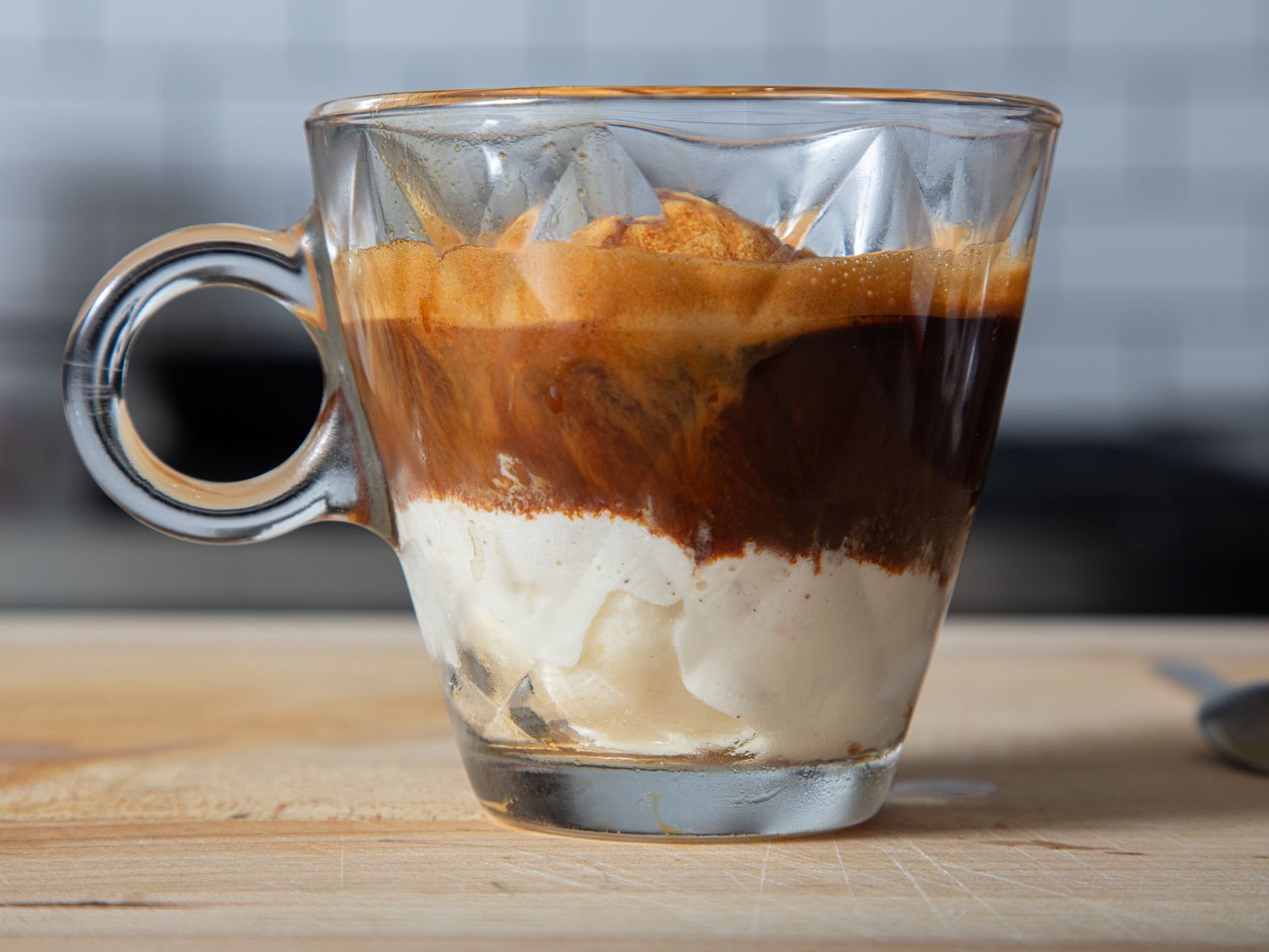 Affogato dessert served in a glass cup, layering gelato topped with espresso