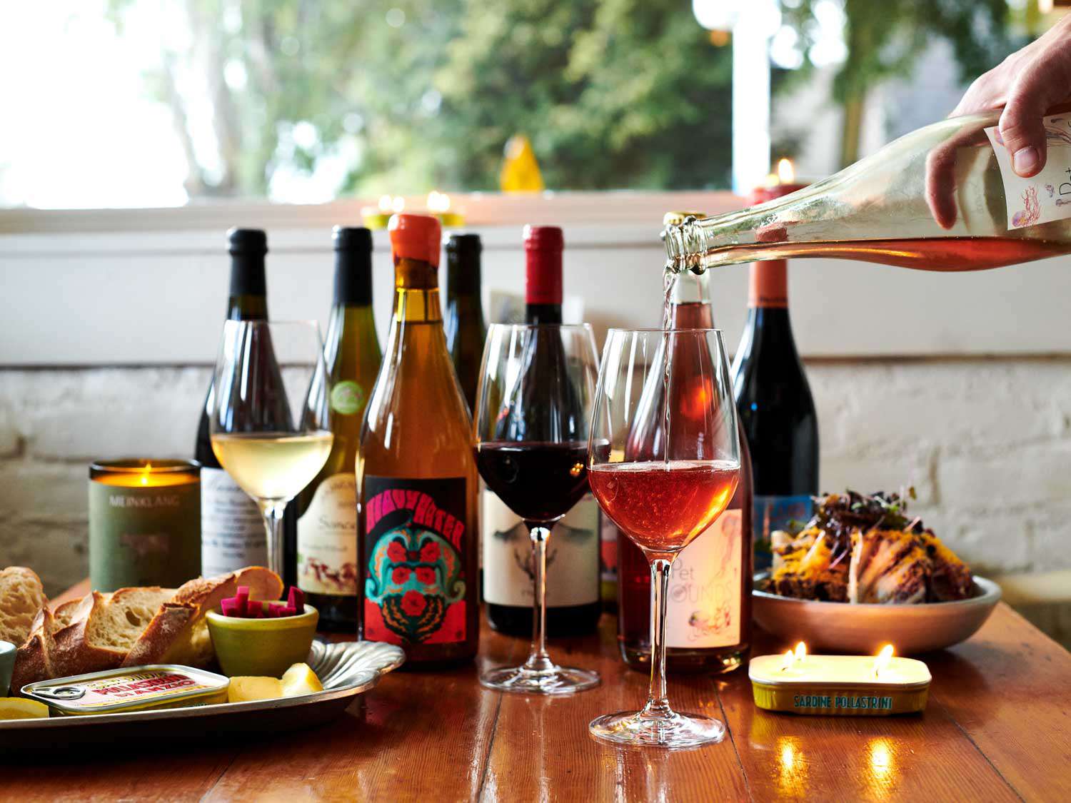 A fully loaded table of wine and food at Sardine Head