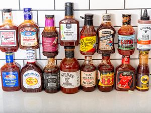 A selection of various barbecue sauce bottles arranged on a counter