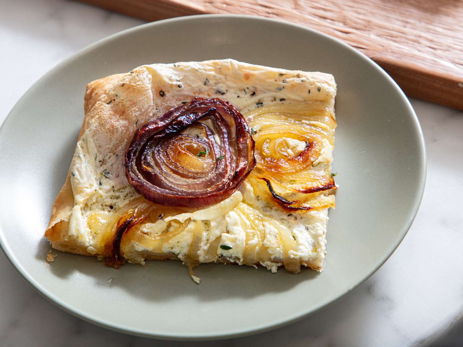 Section of onion tart on a plate