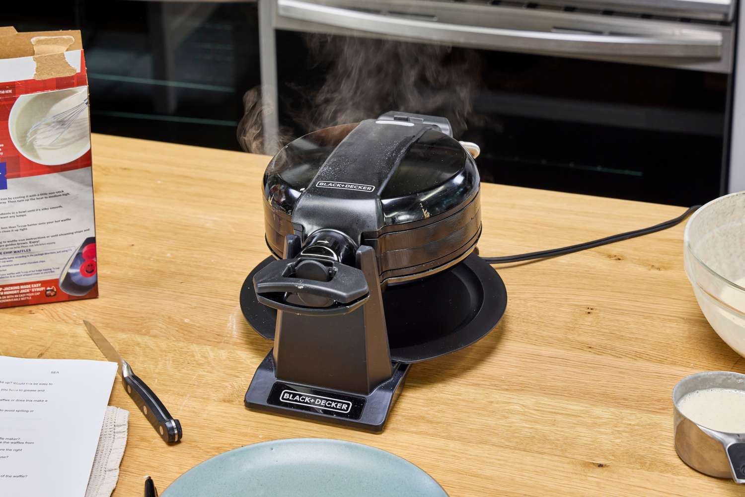 The Black+Decker Double Flip Rotating Waffle Maker steams while making a waffle