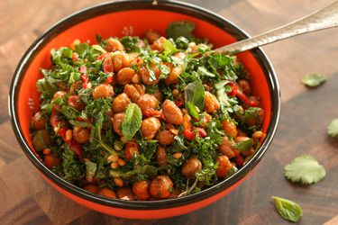 bowl of roasted chickpea, sun-dried tomato, herb, and kale salad with pine nuts