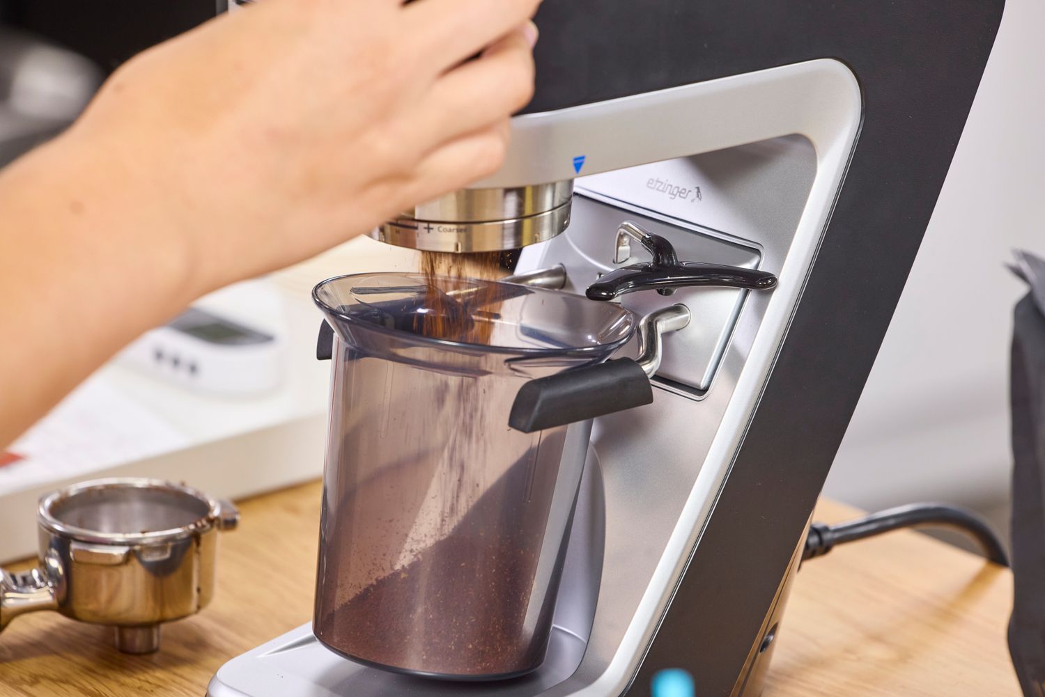A person operates the Baratza Sette 270 Conical Burr Grinder