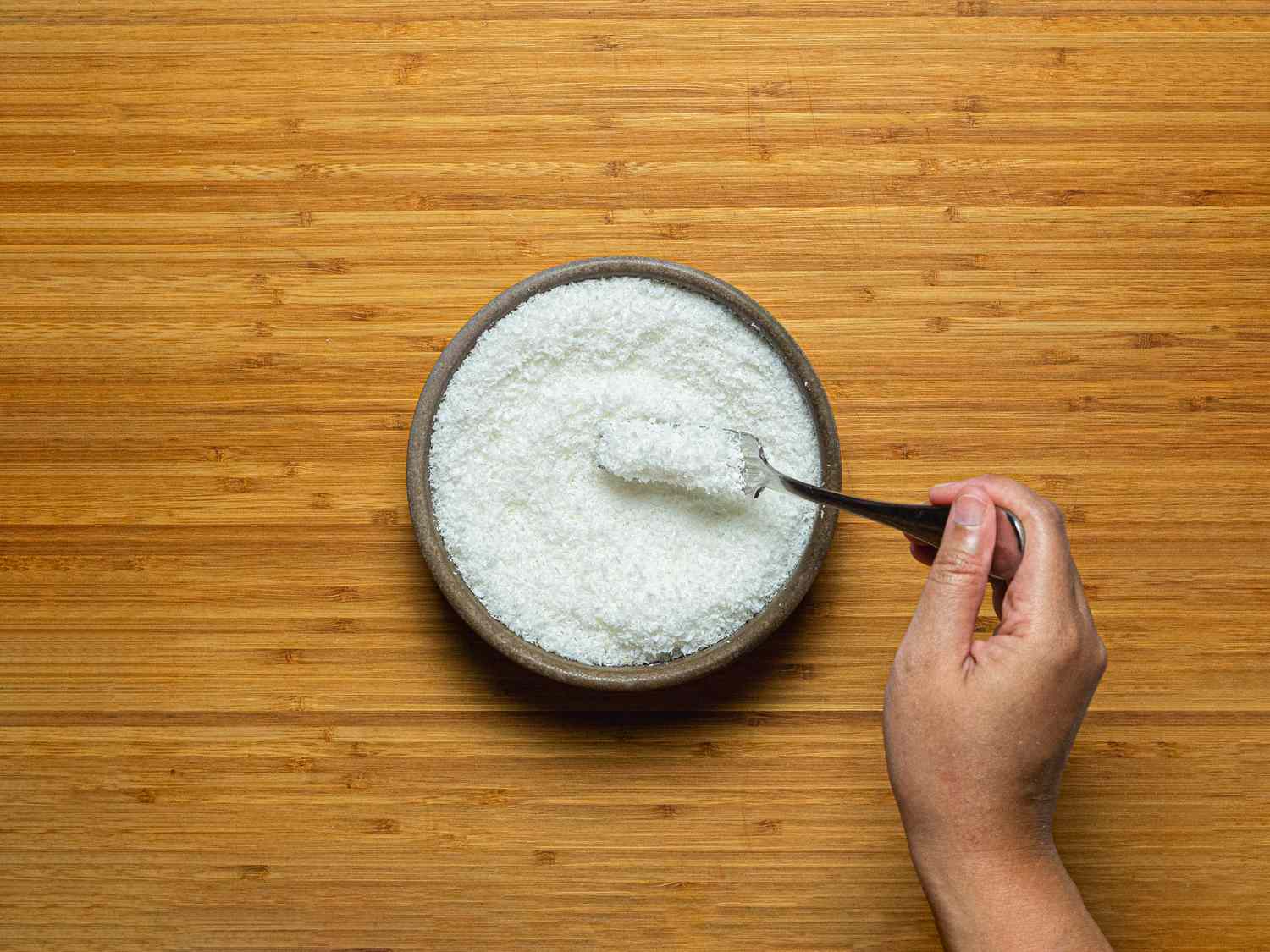 Overhead view of fluffing coconut flakes