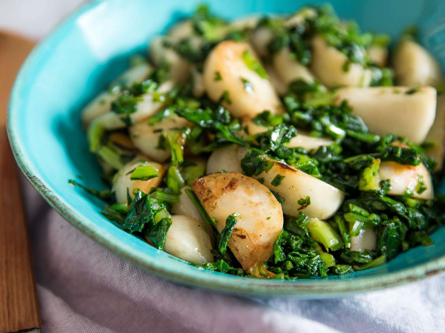 Bowl of sautéed Japanese turnips and greens.