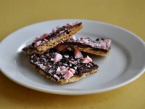 A plate holding three pieces of peppermint bark.