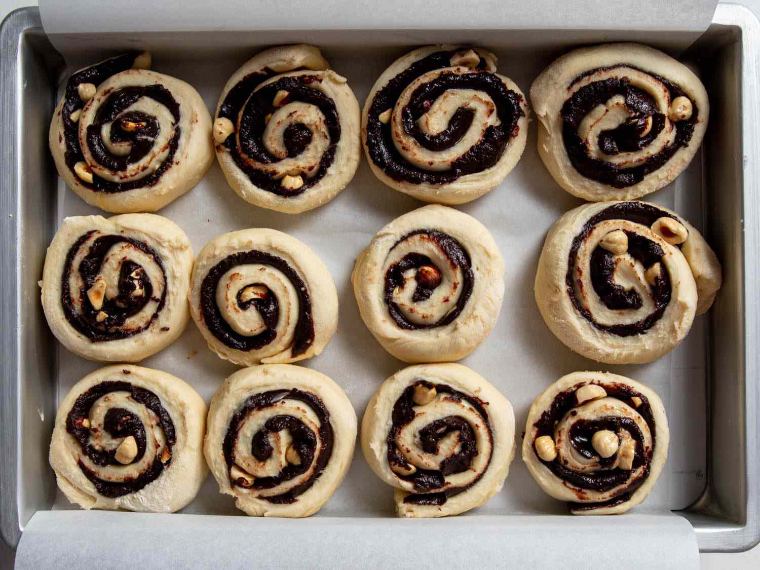sliced pinwheels of chocolate hazelnut dough in a brownie pan