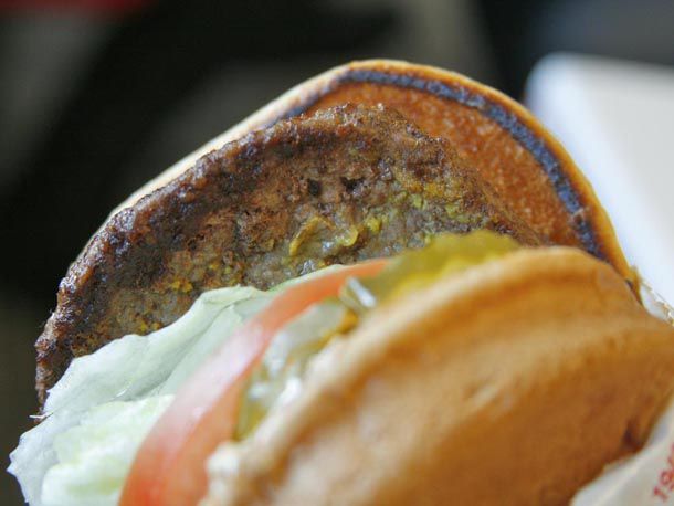 An In-N-Out burger that has been grilled in mustard