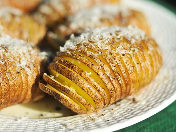 Closeup of the prepped, par-cooked potatoes, dusted with parmesan cheese.