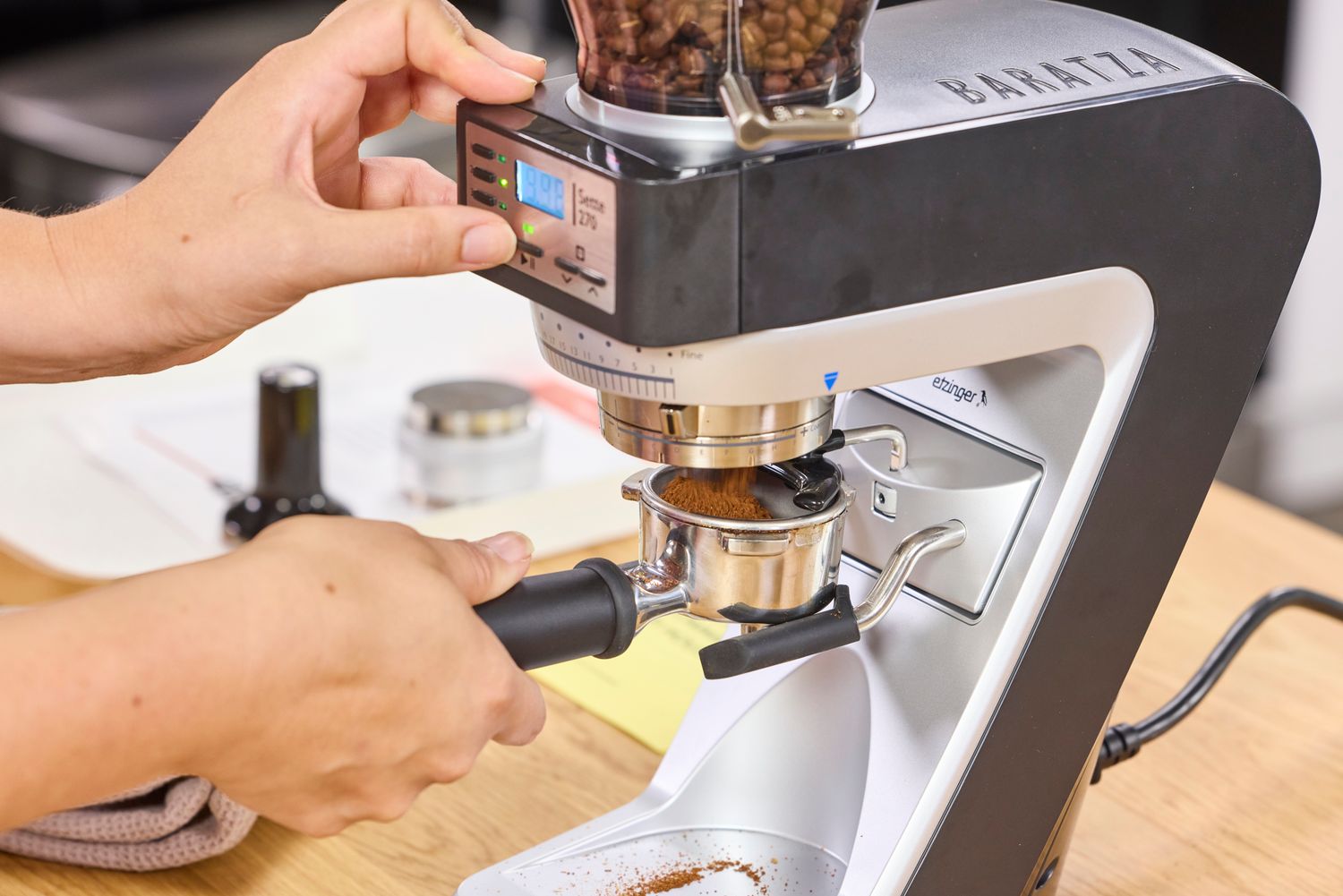 A person uses the Baratza Sette 270 Conical Burr Grinder