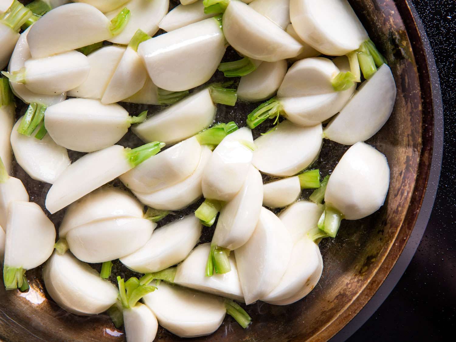 Wedges of Hakurei (Japanese) turnips in a skillet.