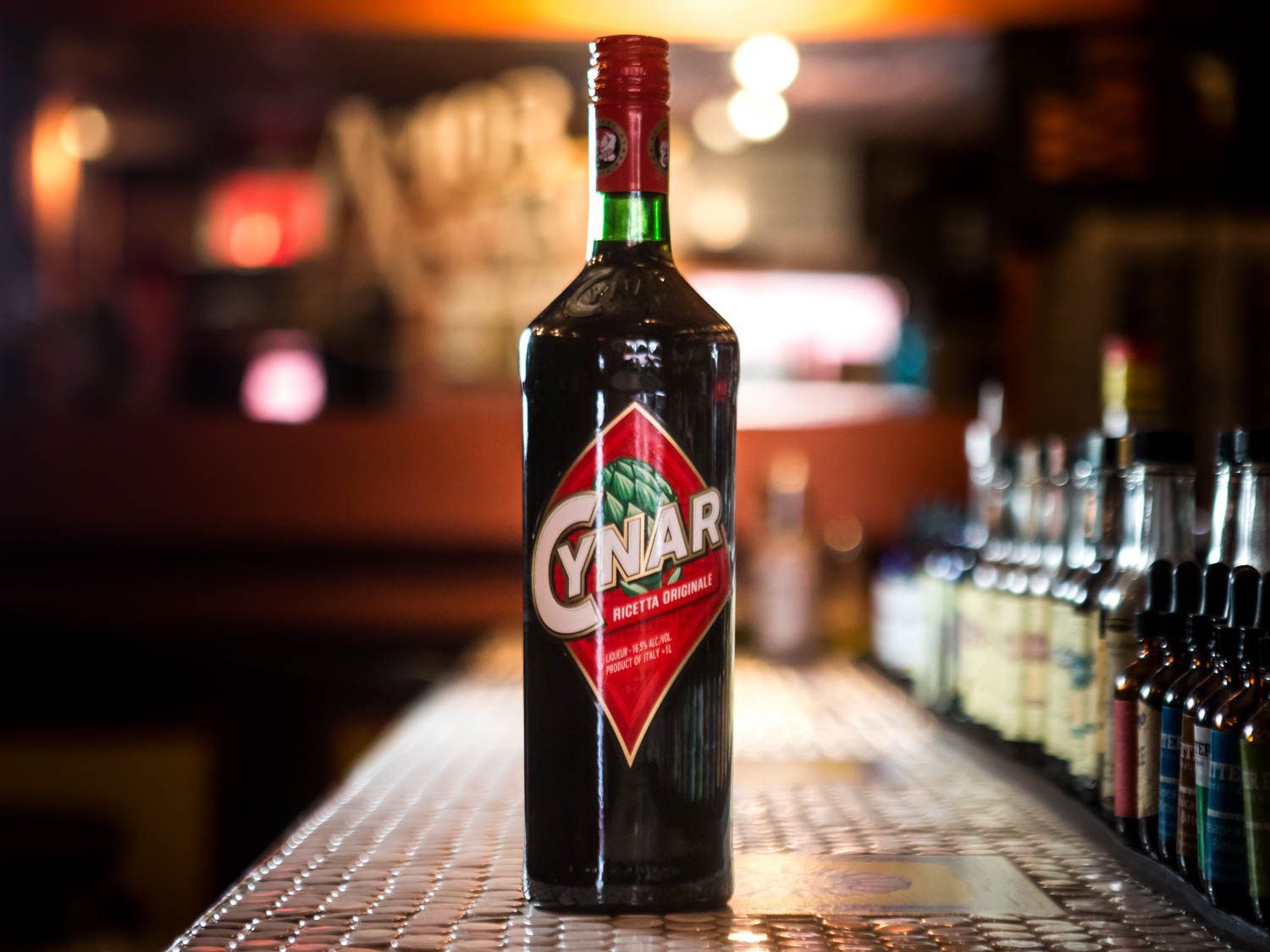 A bottle of Cynar on a bar counter. 