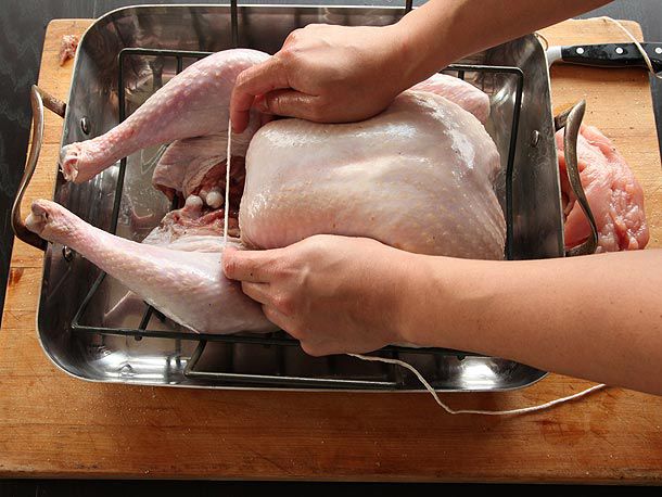 Kitchen twine looped under breast bone