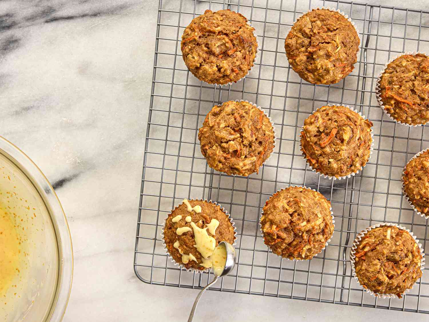 Overhead view of glazing muffins