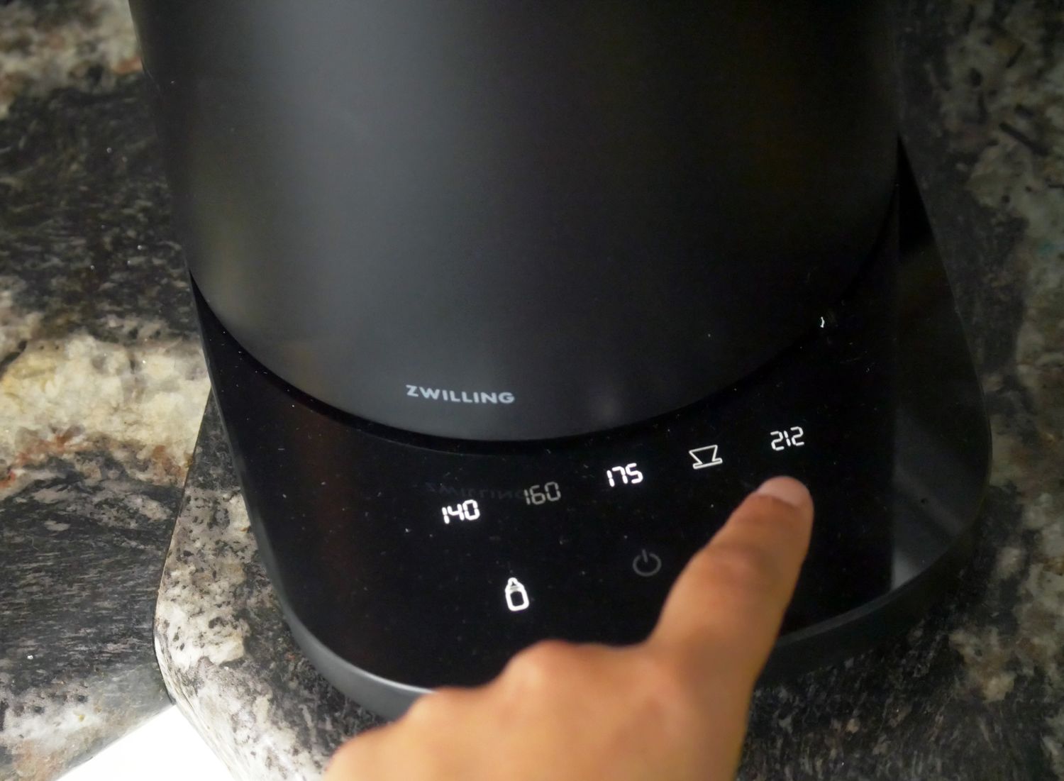 a person setting the temperature on the Zwilling kettle