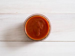 A small bowl of buffalo barbecue sauce. 
