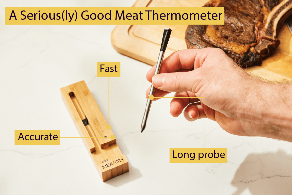 A person holding a wireless meat thermometer. A cooked steak is on a cutting board beside the thermometer.