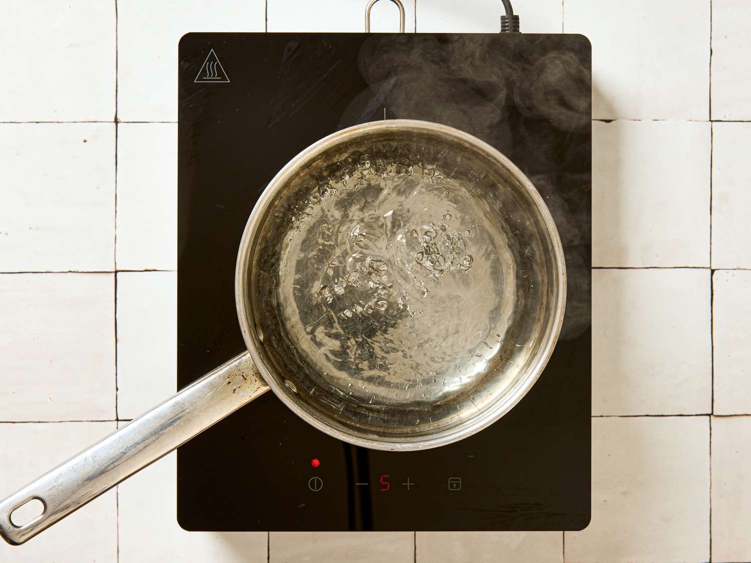 Pot on an induction stovetop heating liquid
