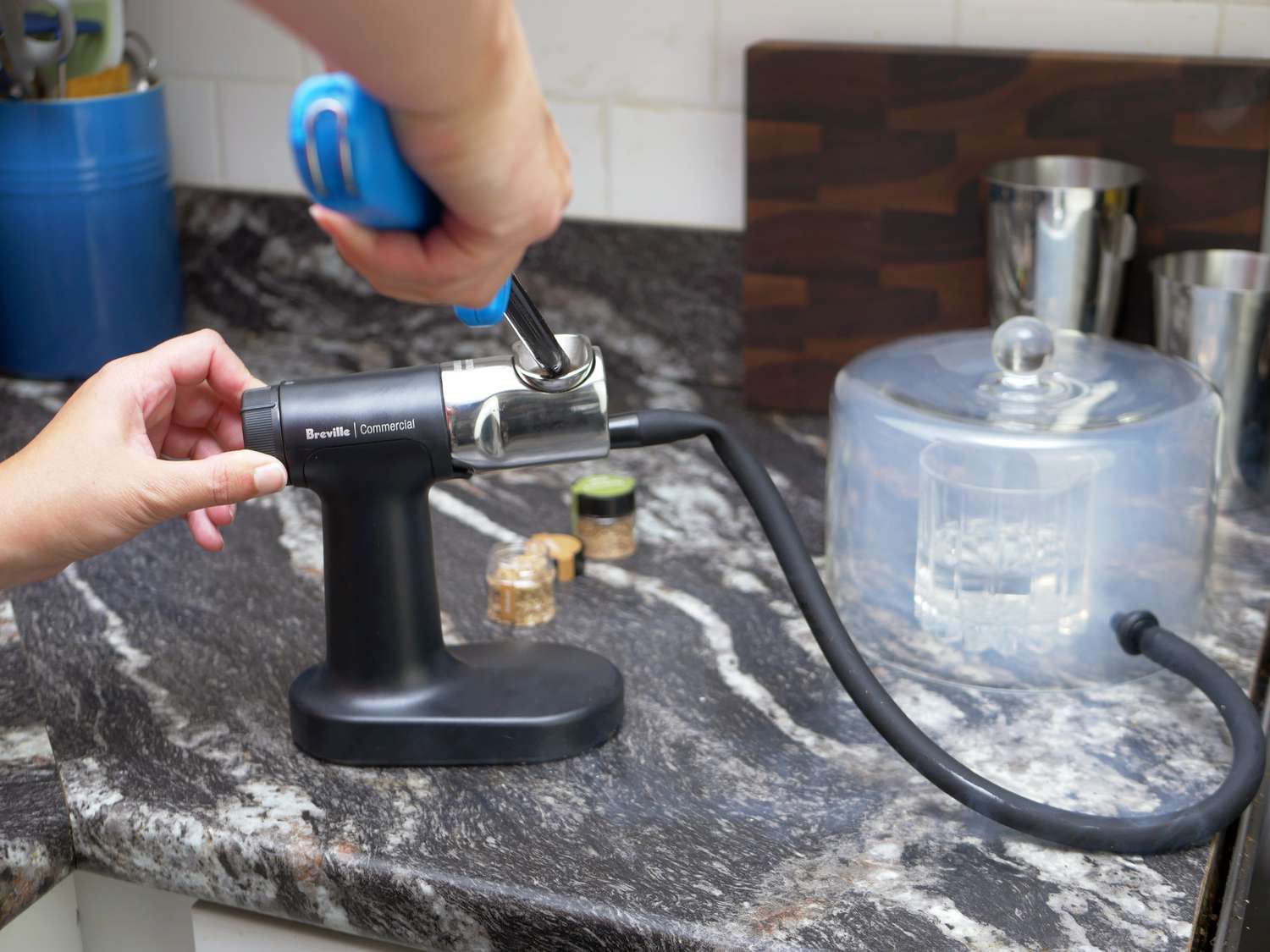 lighting the cocktail smoker and turning the fan on