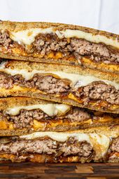 Stacked and sliced-in-half patty melts.