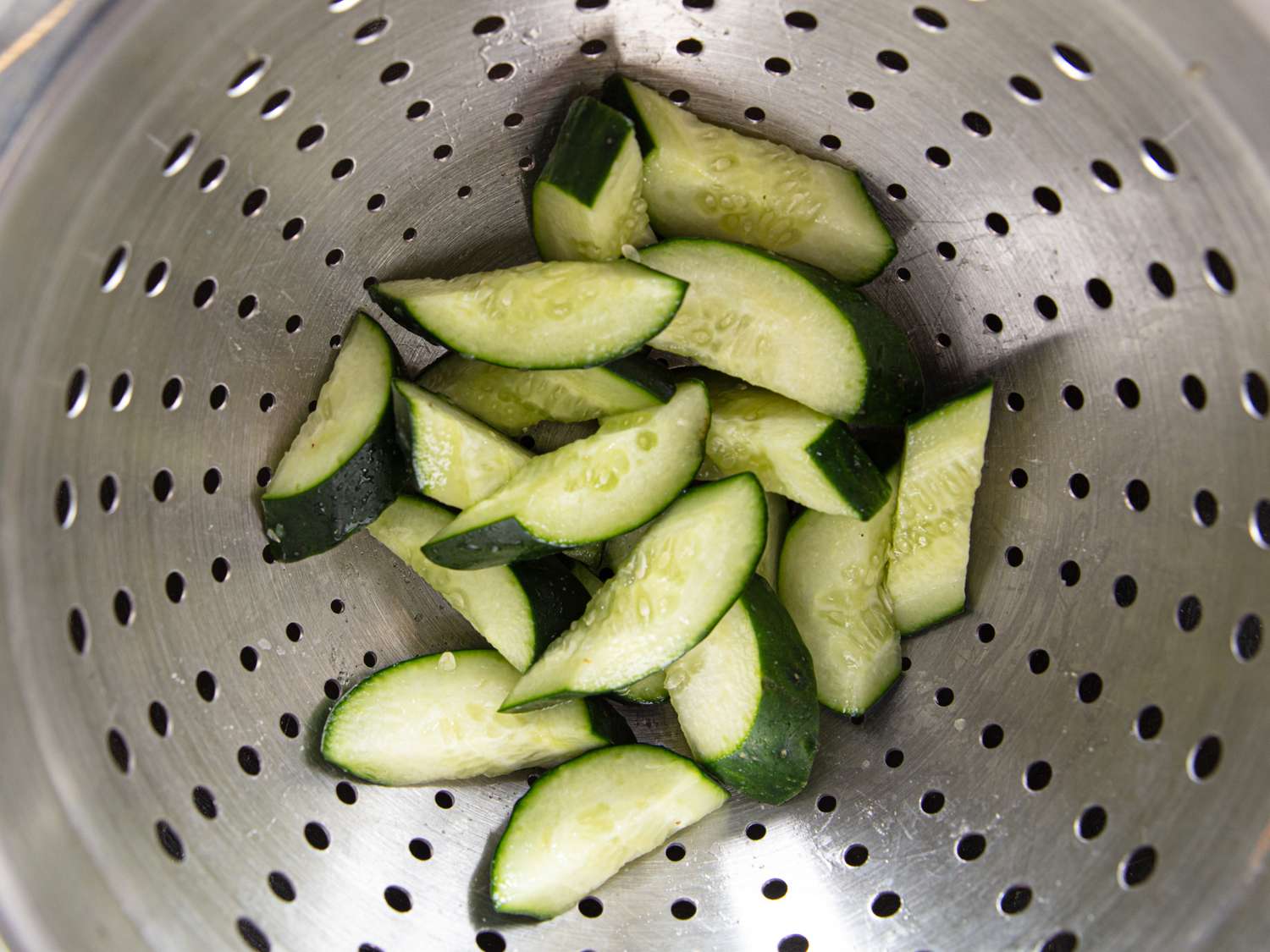 Cut cucumber slices in a colander