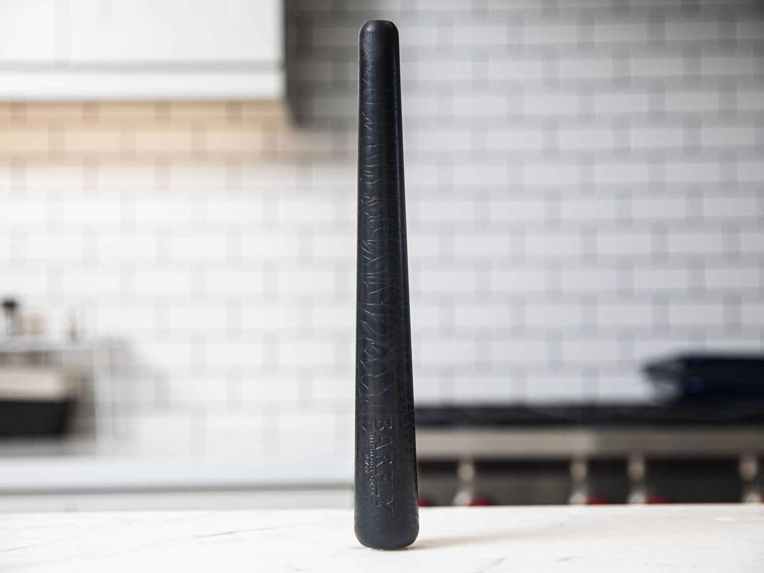 The Barfly Muddler sitting vertically on a kitchen countertop