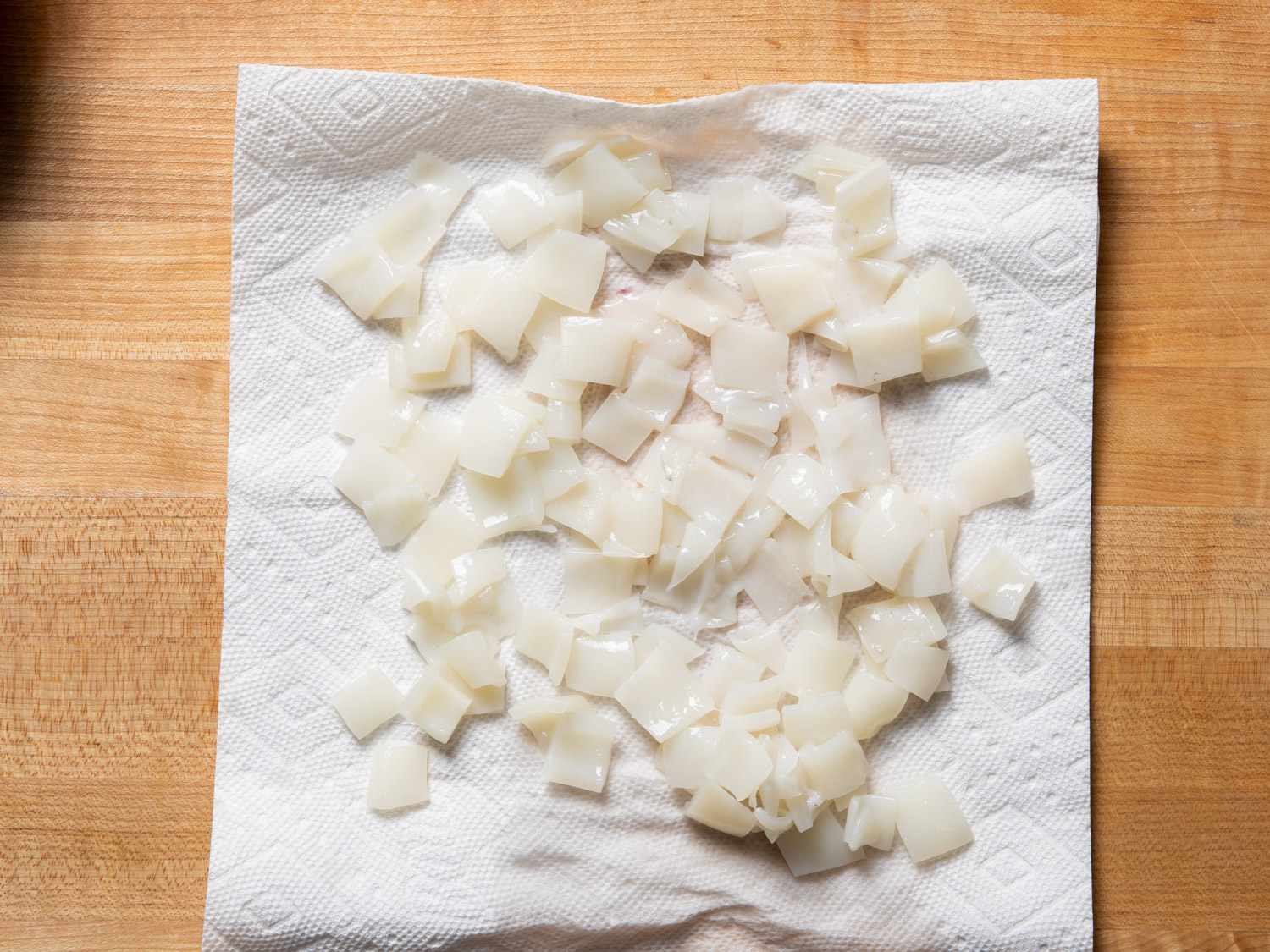 Cut-up squid balls on a paper towel