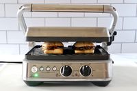 a panini press pressing two vegetarian sandwiches