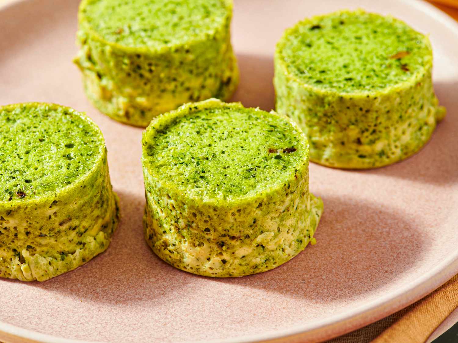Four kale and mushroom egg bites on a plate