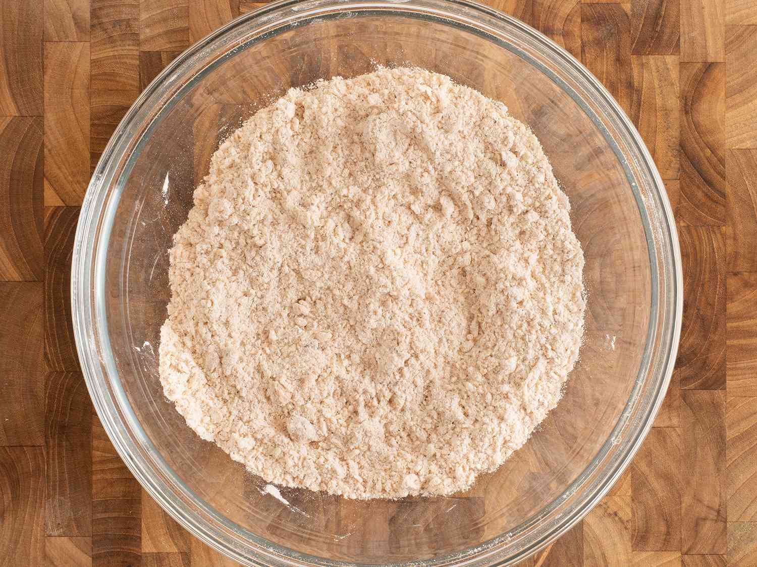 Flour and other ingredients mixed together with a few tablespoons of the egg-milk mixture until the texture is coarse like wet sand.