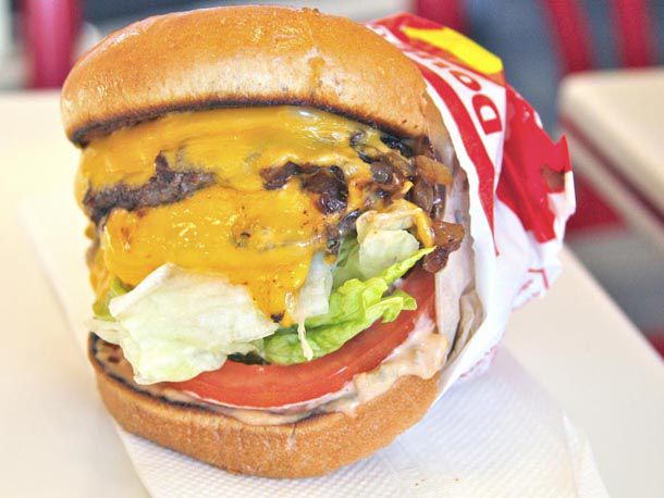 A Double-Double, Animal Style In-N-Out burger with two patties, two slices of cheese, and grilled chopped onions