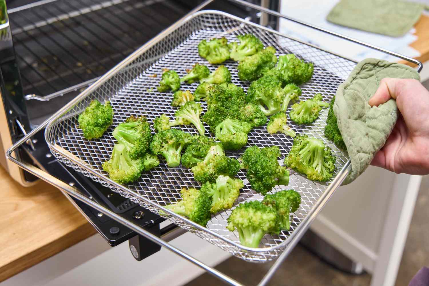 Broccoli is cooked in the KitchenAid Dual Convection Countertop Oven basket