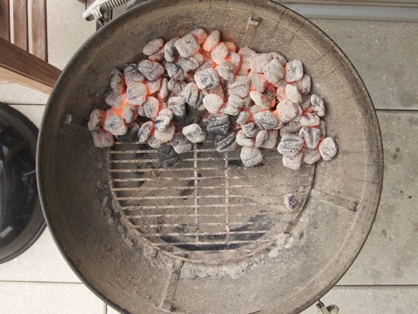A two-level fire set up where hot coals are lit and pushed to one side of the grill. 