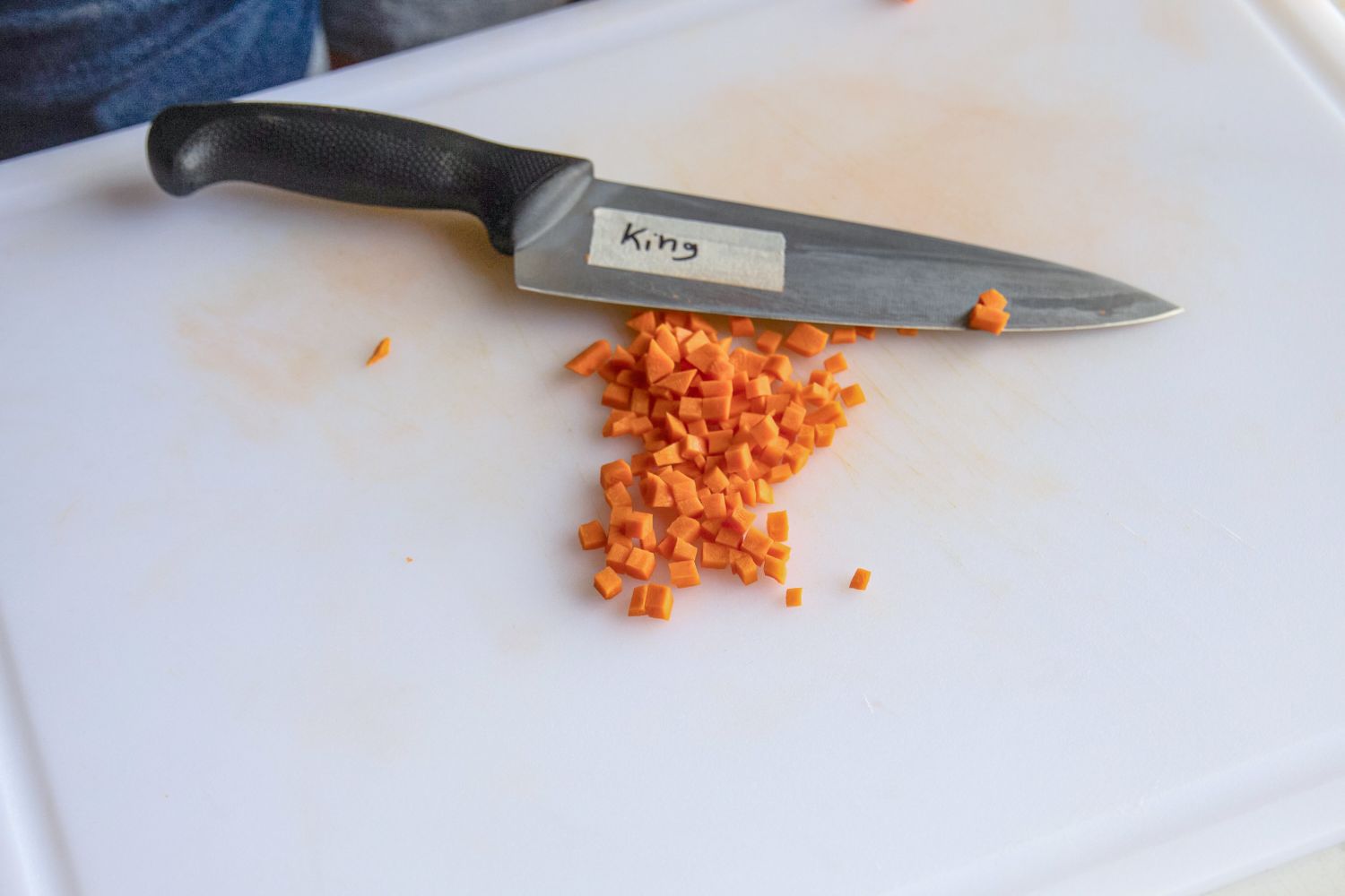 Diced carrots next to a knife 