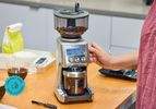 A person adjusting the dial of the Breville Smart Grinder Pro.