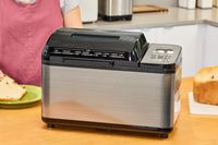 The closed Zojirushi Home Bakery Virtuoso Plus Bread Maker on a wooden counter