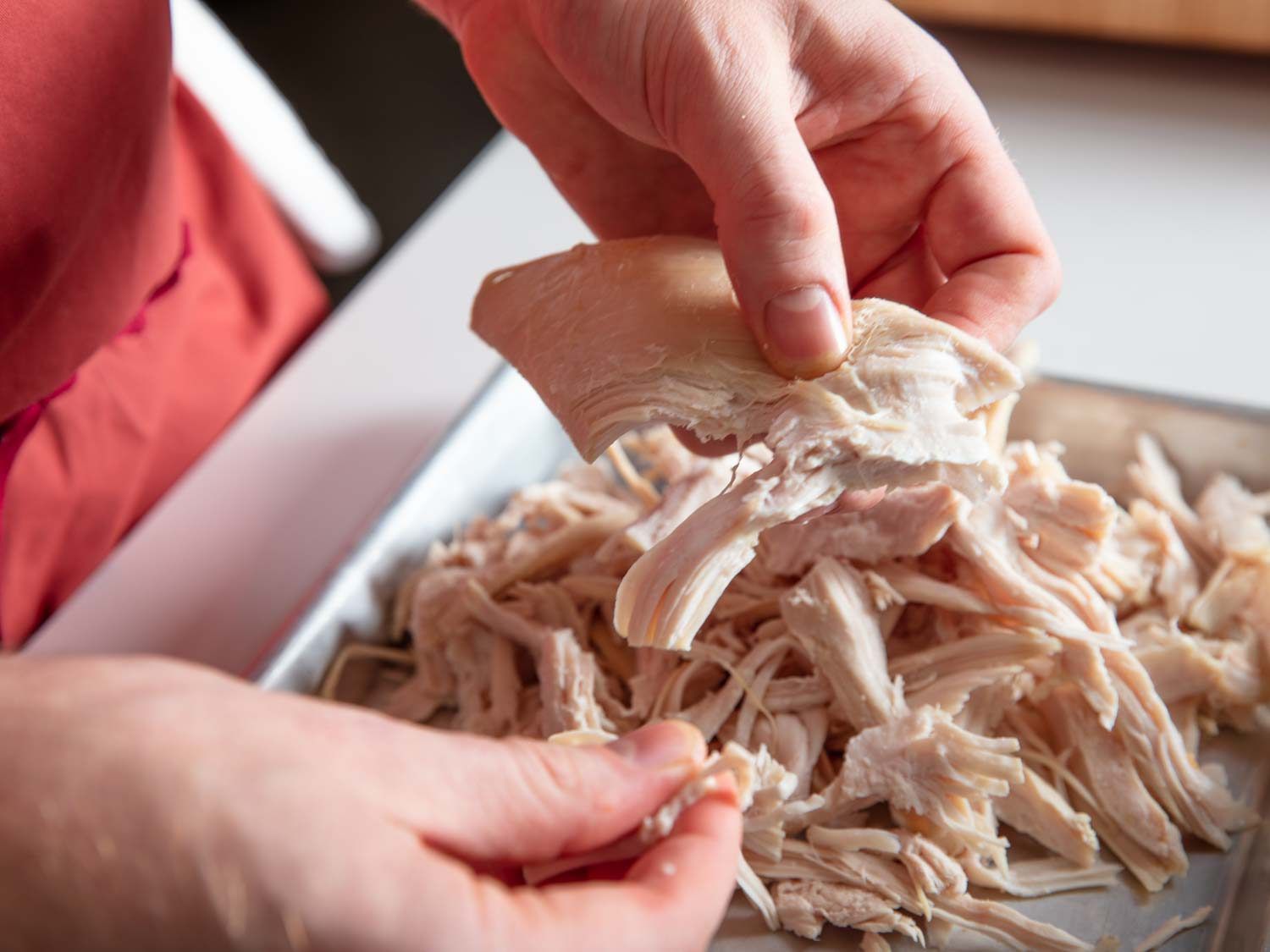 Shredding leftover roast turkey by hand.