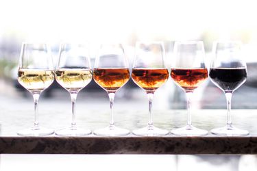 Six wineglasses of sherry, ranging from light to dark
