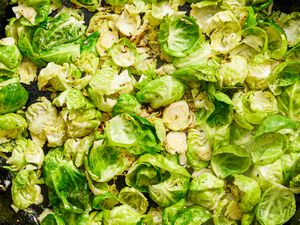 Cooked brussels sprouts sliced and arranged on a pan