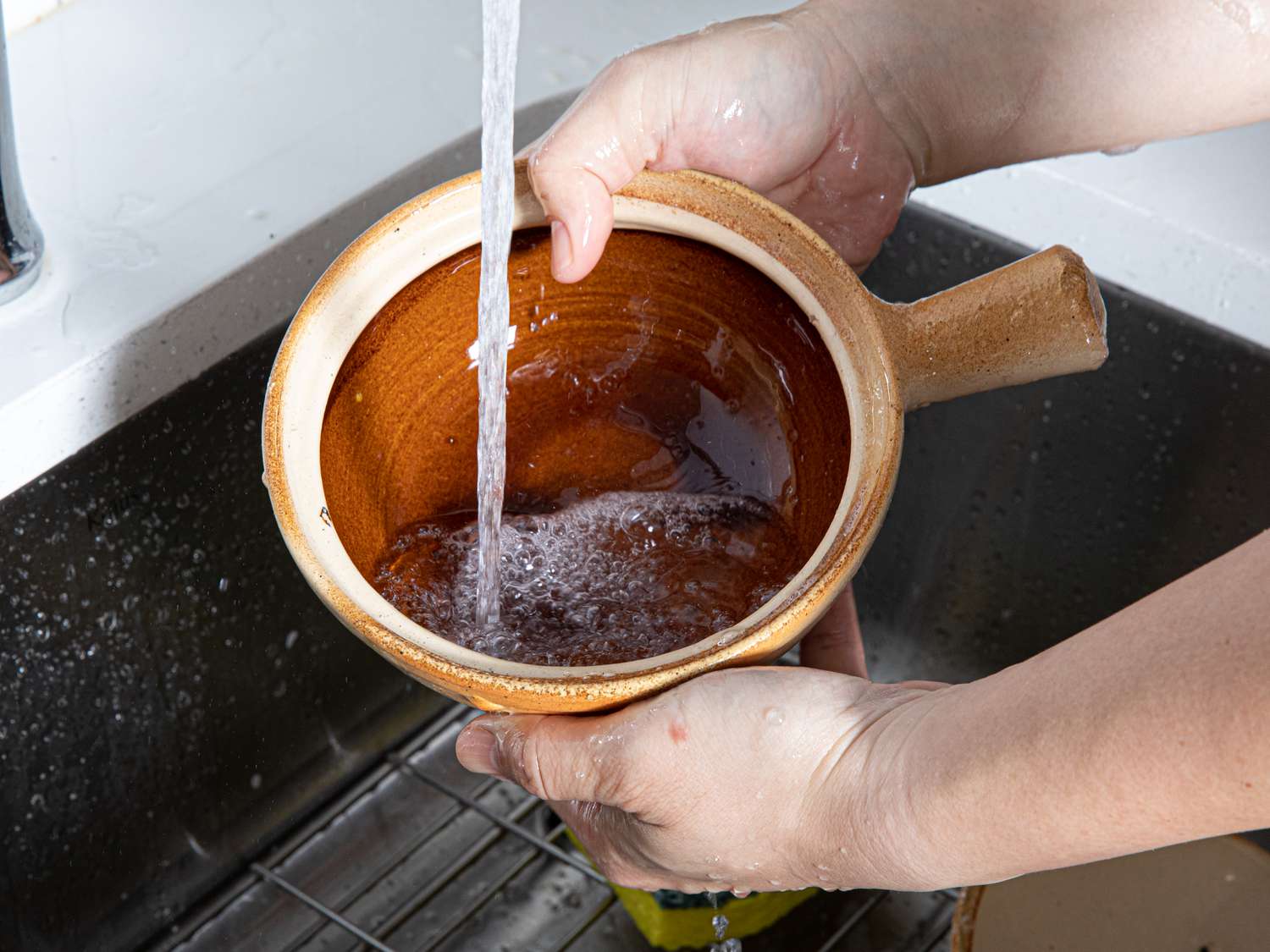 Washing a Cantonese clay pot.