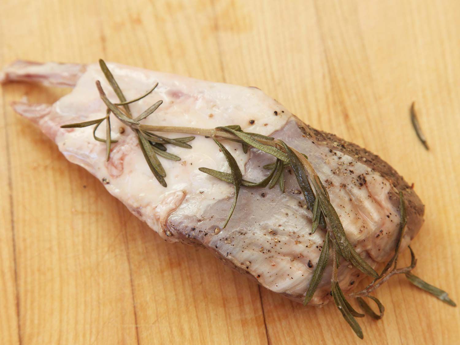 Sous vide lamb ribs with a sprig of rosemary on top