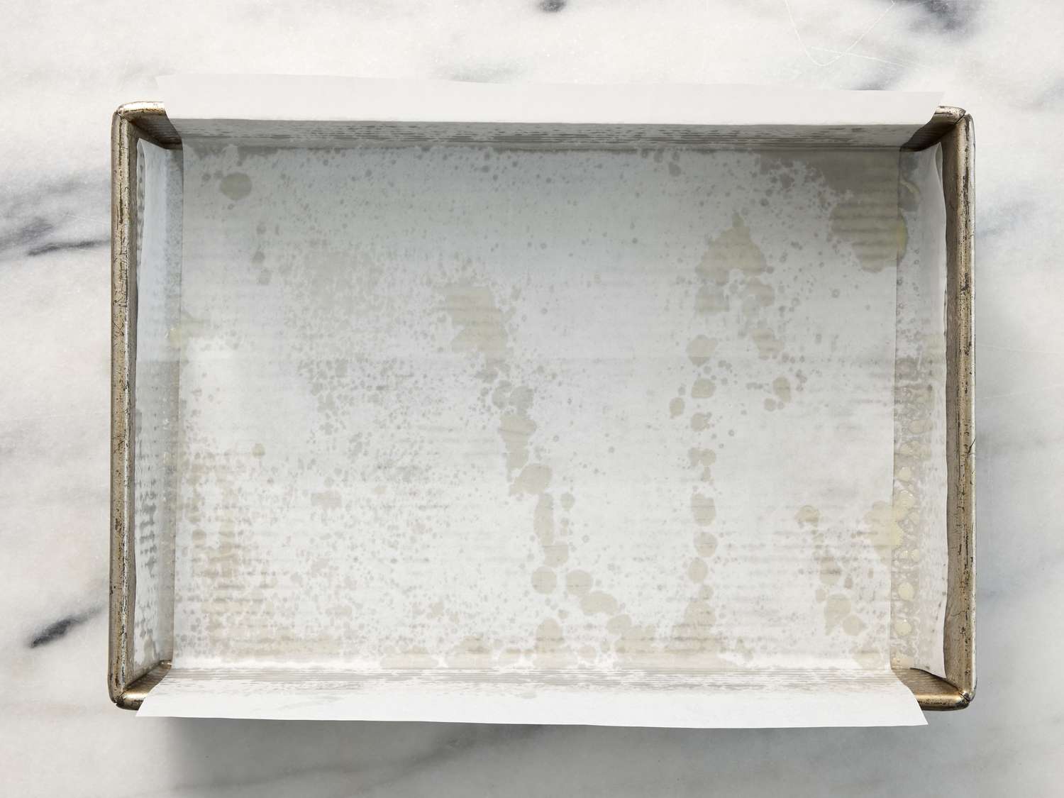 baking pan lined with parchment paper with overhang on each side 