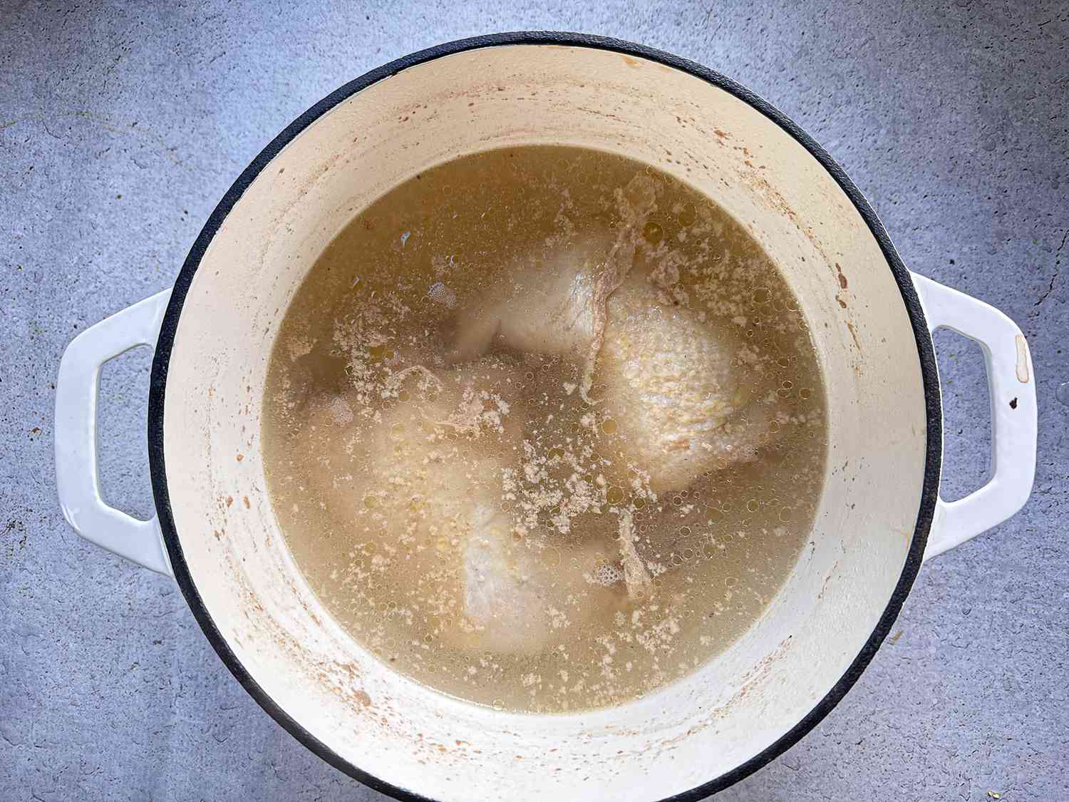 Large pot of chicken boiled in water 